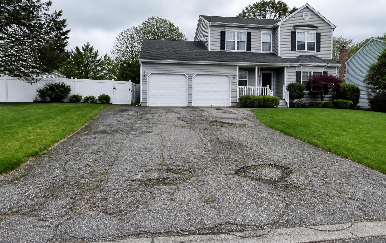 Cracked & Failing — asphalt driveway by GDL Exterior Solutions